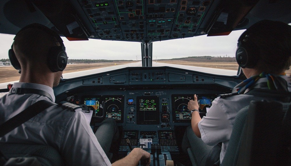 two pilots in cockpit before takeoff
