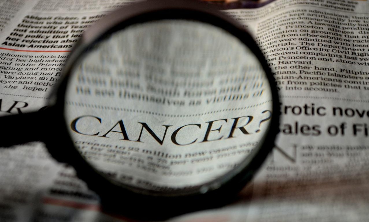 cancer headline with magnifying glass