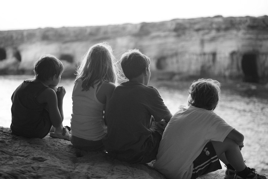 four_children_seated_back_view