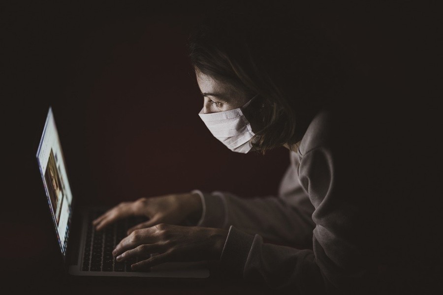 masked-person-at-laptop
