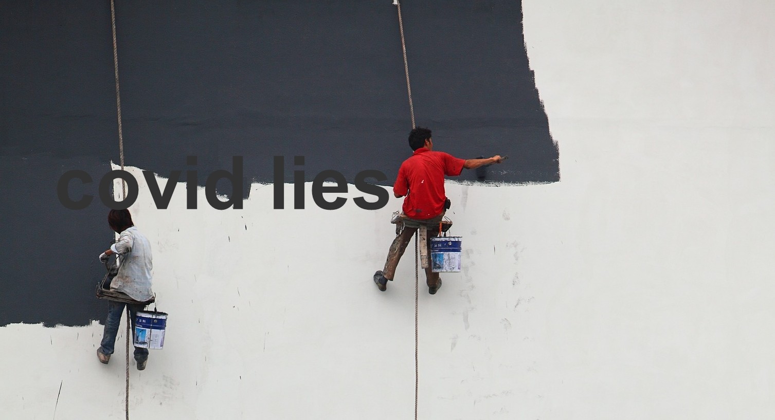 two men suspended painting a wall