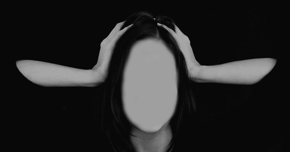 faceless woman holding her head