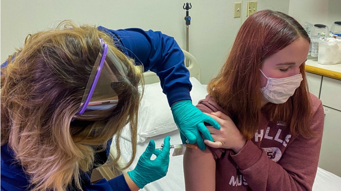 child being injected by a nurse