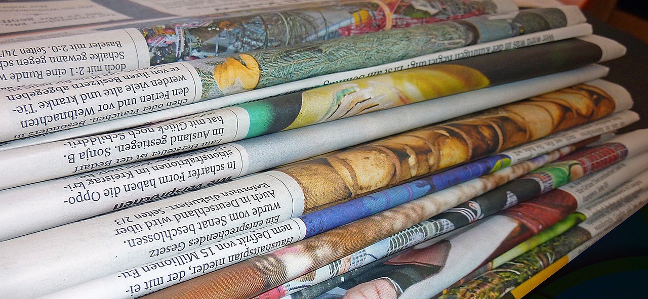 stack of folded newspapers