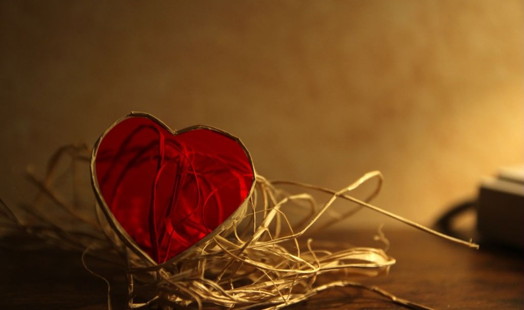 decorative red glass heart with straw