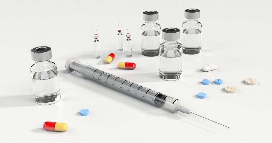 a syringe, vials and pills