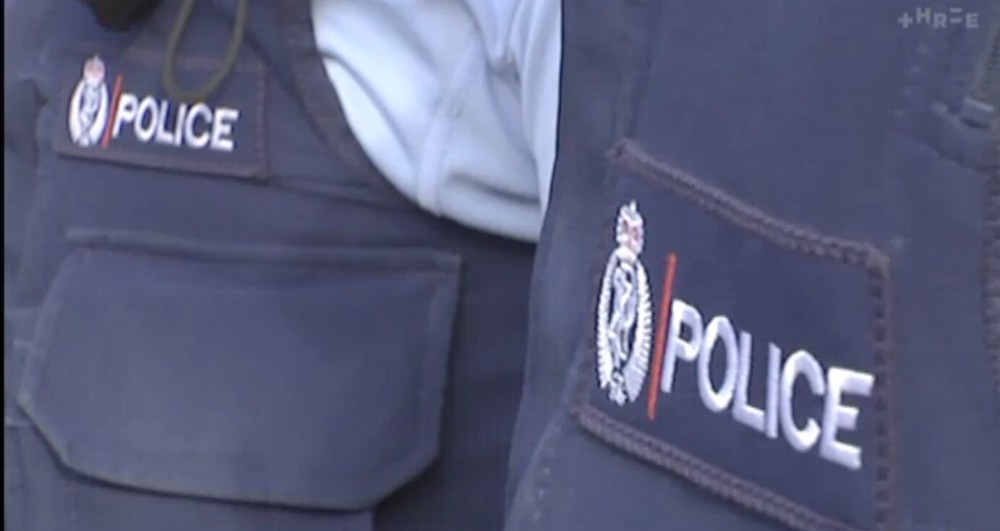 two nz police in uniform with insignia 