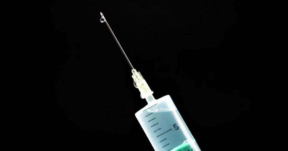drawn syringe with drops