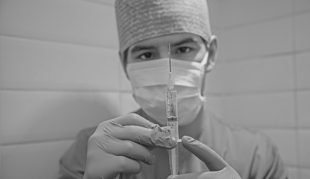 masked medic with syringe